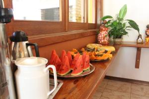 a table with two plates of watermelons and bread at Pousada Lapa Grande in Serra do Cipo