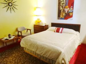 a bedroom with a bed and a table and a chair at Itty Bitty Inn in North Bend