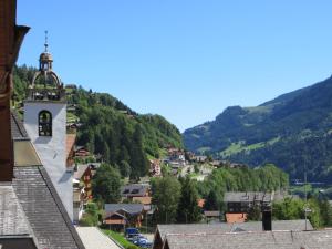 a view of a town with a mountain at Hotel Suisse in Champéry