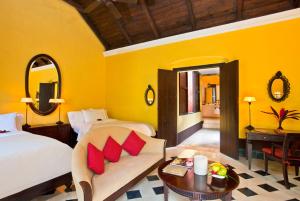 a bedroom with a bed and a couch and a table at Hacienda Uayamon in Uayamón