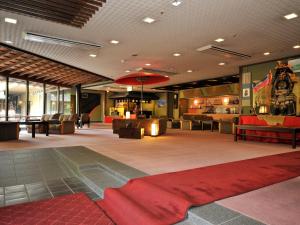 a lobby with a red rug on the floor at Nisshokan Bettei Koyotei in Nagasaki