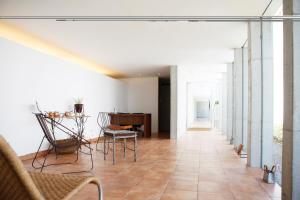 a hallway of a house with a table and chairs at Auberge de Oishi in Takamatsu