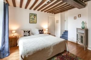 a bedroom with a large bed and a fireplace at Château Turgot Gîtes in Bons-Tassily