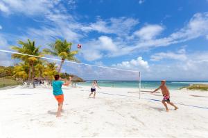 a group of people playing volleyball on a beach at Village Pierre & Vacances Sainte Anne in Sainte-Anne