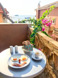 a breakfast table with eggs and a cup of coffee at Yria Hotel in Zakynthos Town