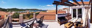 a balcony of a house with a view of the water at Villa Cherie in Sutomišćica