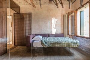 A bed or beds in a room at La Canonica