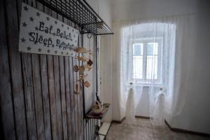 a room with a window and a sign on the wall at Apartment Dolores in Cres +35 photos