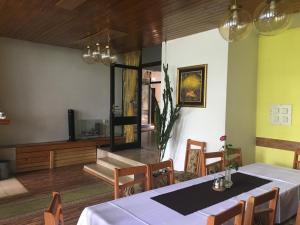 a dining room with a table and chairs at Hotel Tatranec in Tatranská Lomnica