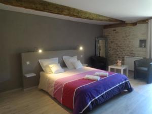 a bedroom with a large bed with two towels on it at Lacoste B&B in Saint-Clair +9 photos