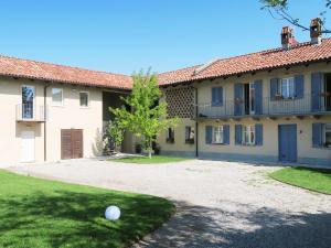 a building with a ball on the ground in front of it at Ca Tupin in Treiso