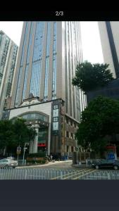 a city with tall buildings and a street with cars at Huizhan Ge Aparthotel in Shenzhen