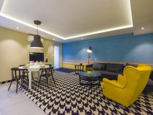 a living room with a couch and a table and chairs at VacationClub - Nadbrzeżna 12 Apartment in Mielno