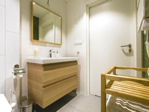a bathroom with a sink and a mirror at VacationClub - Nadbrzeżna 12 Apartment in Mielno