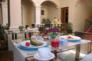 a table with plates of food on top at Hotel Boutique Casa Catrina in Oaxaca City