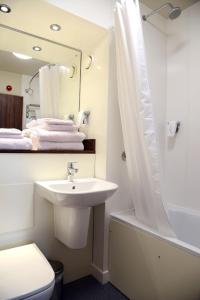 a bathroom with a sink and a toilet and a mirror at Blue Jay, Derby by Marston's Inns in Derby