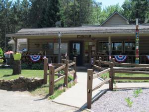 a building with a fence in front of it at Yukon Trails Camping Resort in Lyndon Station