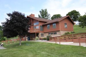 a large wooden house with a wooden fence at Neshonoc Lakeside Camping Resort in West Salem