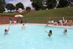 a group of women in a swimming pool with a ball at Neshonoc Lakeside Camping Resort in West Salem