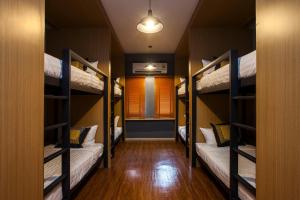 a hallway with four bunk beds in a room at GN Luxury Hostel in Bangkok