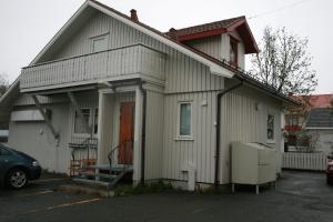 a house with a car parked in front of it at Sentralen inn in Andenes