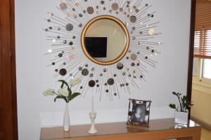 a mirror on a wall in a room with a table at Knossos by Heloni Apartments in Heraklio