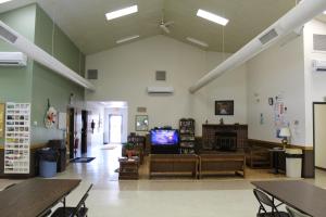 a large room with tables and a tv in it at Pine Country Camping Resort in Belvidere