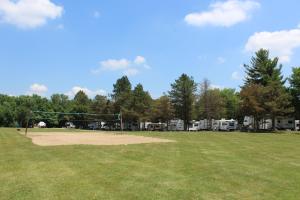 a park with a volley ball court at Pine Country Camping Resort in Belvidere