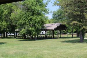 a pavilion in a park with trees and grass at Pine Country Camping Resort in Belvidere