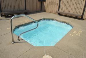 a small swimming pool with a hand rail in a sidewalk at Wilmington Camping Resort in Wilmington