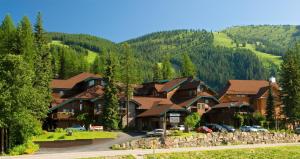a village in the mountains with cars parked at Kandahar Lodge at Whitefish Mountain Resort in Whitefish