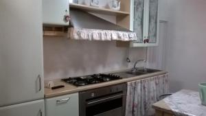 kuchnia z kuchenką i zlewem w obiekcie Casa vacanza Simone w mieście Andria