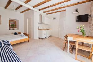 a bedroom with a bed and a desk in a room at Apartments Aerial in Dubrovnik
