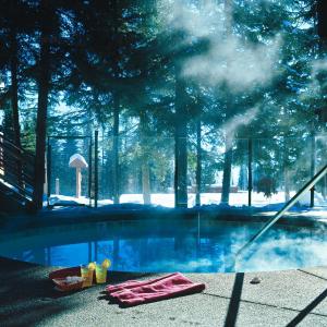 a swimming pool with a pink towel next to it at Kandahar Lodge at Whitefish Mountain Resort in Whitefish