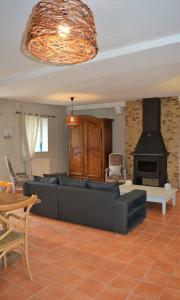 a living room with a couch and a fireplace at Gite De Saba in La Celle-Condé