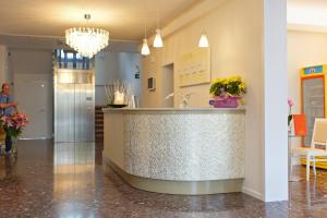 a lobby with a counter with a sink at Hotel Albatros in Lido di Jesolo