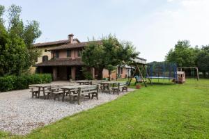 a group of picnic tables and a playground at Agriturismo Borg da Ocjs in Cormòns