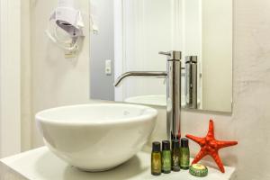 a bathroom with a sink and a starfish on a counter at Candia Studios & Rooms in Heraklio Town +35 photos