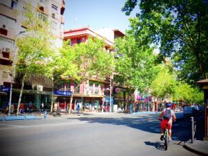 a man riding a bike down a city street at Casa de Huéspedes Almansa in Madrid
