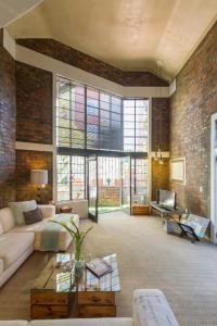 a living room with a couch and a table at Waterkant Loft in Cape Town +31 photos