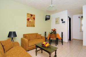 a living room with two couches and a table with fruit on it at Elea Houses in Mithymna