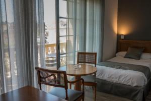 a hotel room with a bed and a table and a window at Nueva Colina in Tomiño +78 photos