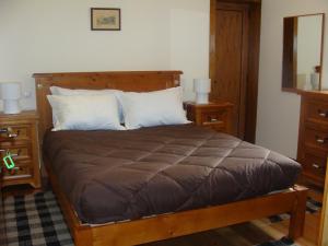 a bedroom with a large bed with two night stands at Solar da Salvadoura in Amares