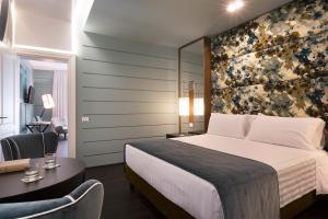 Voodi või voodid majutusasutuse Stendhal Luxury Suites toas