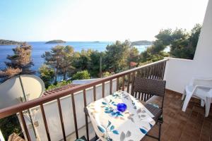 a balcony with a table and chairs and the ocean at Apartments Lea in Prizba