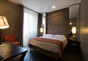 Voodi või voodid majutusasutuse Stendhal Luxury Suites toas