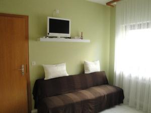 a bedroom with a bed with a tv on the wall at Gästehaus Andrea Blatt in Bruttig-Fankel