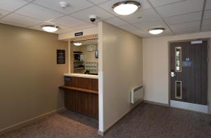 a hallway of a waiting room with a door at Fallow Field, Telford by Marston's Inns in Telford