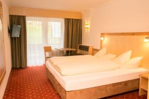 Кровать или кровати в номере Hotel Garni Ehrenreich