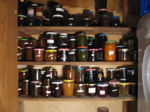 a shelf filled with lots of jars of food at La Croix De Camargue in Oradour-sur-Glane